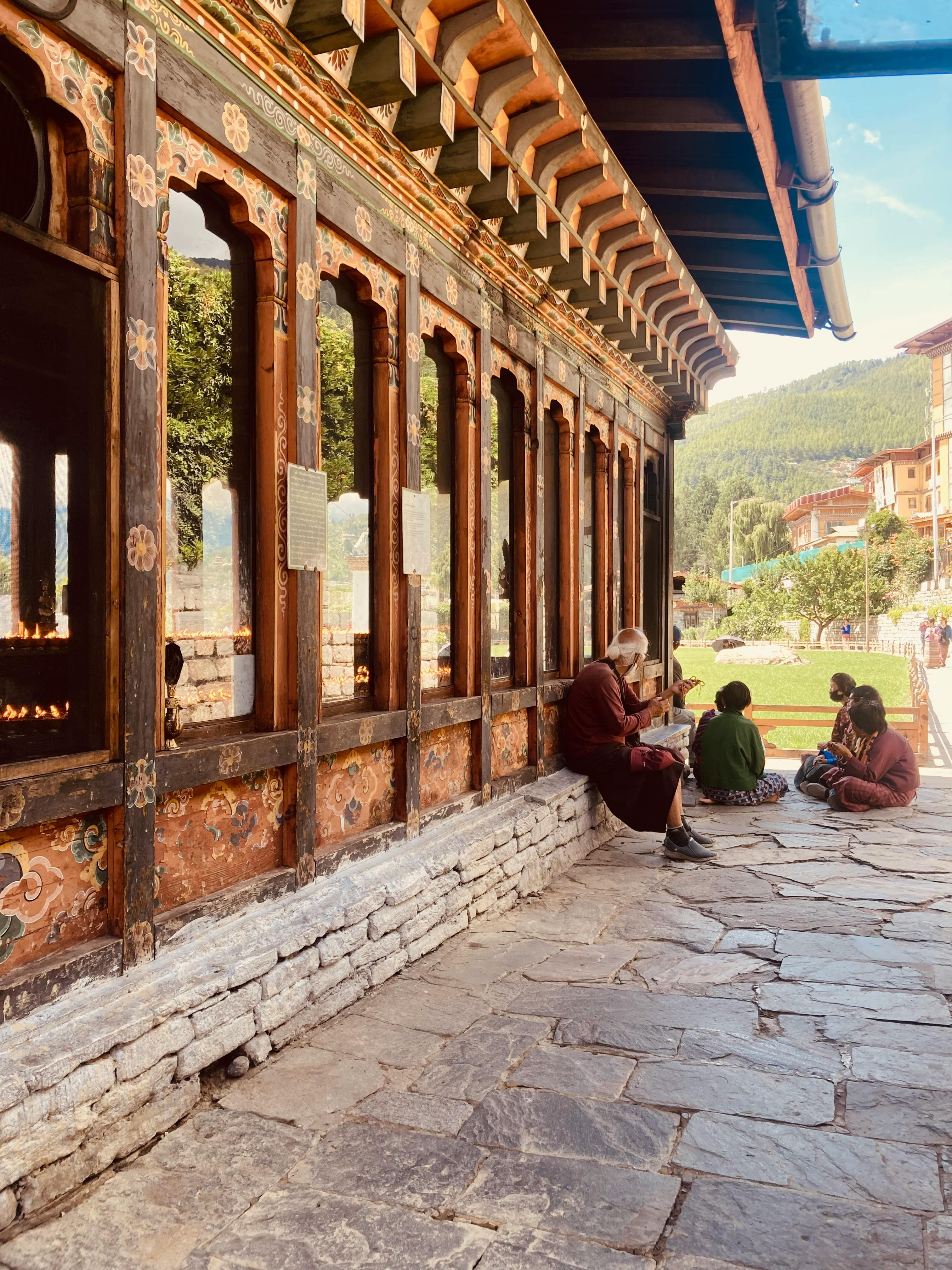 Intricate Bhutanese wood carvings painted in red and gold inside a sacred dzong