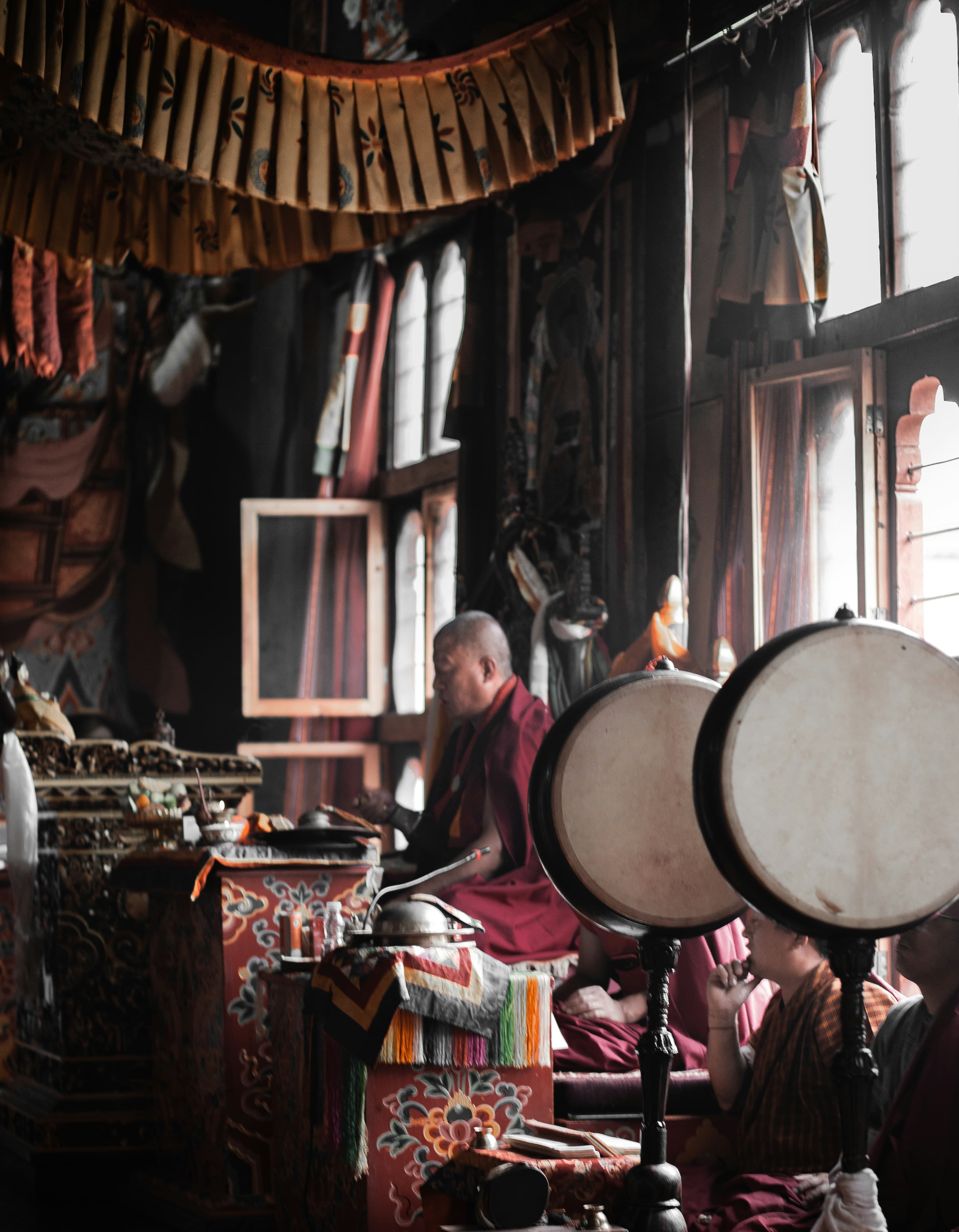 Intricate Bhutanese wood carvings painted in red and gold inside a sacred dzong